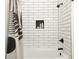 Bright shower showcasing sleek white subway tiles and a black rainfall shower head at 1425 Kennington St, Indianapolis, IN 46225