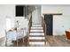 Elegant staircase with modern railing next to a dining area at 1425 Kennington St, Indianapolis, IN 46225