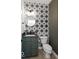 Charming half bath featuring a modern vanity, circular mirror, and star pattern accent wall at 1452 E Greyhound E Pass, Carmel, IN 46032