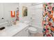 Bright bathroom featuring a white vanity, modern fixtures, and a stylish orange-themed shower curtain at 1452 E Greyhound E Pass, Carmel, IN 46032