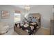 Charming bedroom with a patterned bedspread, soft chair, and ample natural light from the window at 1452 E Greyhound E Pass, Carmel, IN 46032