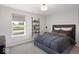 Comfortable bedroom with a large bed, window view, and rustic wall shelves, providing a cozy retreat at 1452 E Greyhound E Pass, Carmel, IN 46032