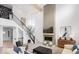 Spacious living room with fireplace, stairs, and modern decor in a well-lit, open-concept home at 1452 E Greyhound E Pass, Carmel, IN 46032