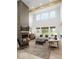 Bright, open-concept living room with a fireplace, high ceilings, and large windows overlooking the exterior at 1452 E Greyhound E Pass, Carmel, IN 46032