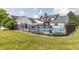 Spacious backyard featuring a swimming pool with black fence, a deck, and a lush lawn at 1595 N 400 W, Greenfield, IN 46140