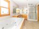 Primary bath featuring a soaking tub, separate shower, double vanity, and tile floors at 1595 N 400 W, Greenfield, IN 46140