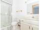 Clean and bright bathroom featuring a shower, toilet, and a sink with storage underneath at 1595 N 400 W, Greenfield, IN 46140