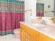 A bathroom with a pink toilet and a sink with matching colored shower curtain at 1595 N 400 W, Greenfield, IN 46140