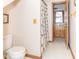 Bright bathroom featuring a toilet, shower, and wood cabinets with open access at 1595 N 400 W, Greenfield, IN 46140