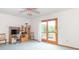 Bright bedroom with a sliding door to the balcony and featuring an office corner and pink fan at 1595 N 400 W, Greenfield, IN 46140