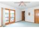 View of a bedroom featuring a sliding door to the balcony and a wooden door and walls at 1595 N 400 W, Greenfield, IN 46140