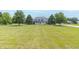 Traditional two-story home featuring a large front yard and a welcoming front porch at 1595 N 400 W, Greenfield, IN 46140