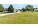 Long shot of a beautiful white home with a lush green yard and two car garage at 1595 N 400 W, Greenfield, IN 46140