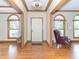 Hardwood foyer with a white front door, natural lighting, and wooden accent trim at 1595 N 400 W, Greenfield, IN 46140