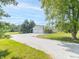 View of the detached two car garage, long driveway and mature tree coverage at 1595 N 400 W, Greenfield, IN 46140