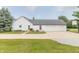 A white home with a black roof, two car garage, and basketball hoop over the driveway at 1595 N 400 W, Greenfield, IN 46140