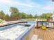 View of a hot tub, swimming pool, and the backyard with lots of green grass and trees at 1595 N 400 W, Greenfield, IN 46140