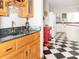 Charming kitchen with black and white checkerboard flooring and a wet bar with ample counter space at 1595 N 400 W, Greenfield, IN 46140