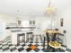 Eat-in kitchen boasting an island, black and white checkerboard flooring, and modern appliances at 1595 N 400 W, Greenfield, IN 46140