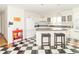 Bright kitchen with black and white flooring, ample counter space, and white appliances at 1595 N 400 W, Greenfield, IN 46140