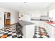 Light and airy kitchen with black and white tiled flooring, an island, and white cabinets at 1595 N 400 W, Greenfield, IN 46140