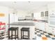 Bright eat-in kitchen featuring an island, black and white checkerboard floor, and white cabinets at 1595 N 400 W, Greenfield, IN 46140
