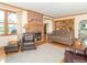 Bright living room featuring a brick fireplace, hardwood floors, and a comfortable seating arrangement at 1595 N 400 W, Greenfield, IN 46140
