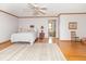 Large main bedroom with wood floors, a ceiling fan, and a view to the ensuite bathroom at 1595 N 400 W, Greenfield, IN 46140