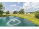 A picturesque pond with a fountain and the main home in the background amid lush surroundings at 1595 N 400 W, Greenfield, IN 46140