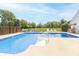 Angled view of an in ground pool that has a ladder, surrounding fence, and lawn chairs at 1595 N 400 W, Greenfield, IN 46140