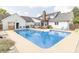 View of the in ground pool, with bar area, and chairs for lounging at 1595 N 400 W, Greenfield, IN 46140