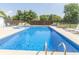 A full view of the in ground pool showing it's size and surrounding trees and landscaping at 1595 N 400 W, Greenfield, IN 46140
