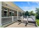 Beautiful back porch with brick and stone features a table, chairs, and grill at 1631 Caspian Dr, Carmel, IN 46032