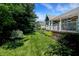Lush green backyard with a well-maintained lawn, beautiful landscaping, and a charming white-railed porch at 1631 Caspian Dr, Carmel, IN 46032