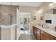 Bathroom boasts double sinks with wood cabinets, neutral walls, a large mirror, and a walk-in shower in view at 1631 Caspian Dr, Carmel, IN 46032