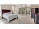 Cozy bedroom with neutral carpet, large windows, a bed, dresser, and side tables at 1631 Caspian Dr, Carmel, IN 46032
