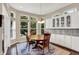 Bright dining area with large windows overlooking outdoors, hardwood floors and built in cabinetry at 1631 Caspian Dr, Carmel, IN 46032