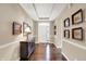 Elegant foyer boasting hardwood floors, decorative trim, and a stylish console table with decorative lighting at 1631 Caspian Dr, Carmel, IN 46032