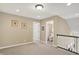 Neutral hallway with access to bedrooms and bathroom, carpet flooring, neutral walls, and decorative artwork at 1631 Caspian Dr, Carmel, IN 46032