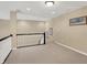 Neutral hallway with carpet flooring, neutral walls, decorative artwork, and staircase with black handrail and white balusters at 1631 Caspian Dr, Carmel, IN 46032