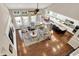 Aerial view of living room with hardwood floors, neutral walls, furniture, and open access to kitchen and dining at 1631 Caspian Dr, Carmel, IN 46032