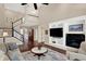 Spacious living room boasting a fireplace, built-in shelving, and views into other living spaces at 1631 Caspian Dr, Carmel, IN 46032