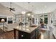 Open concept living room with vaulted ceilings, fireplace, hardwood floors, and connected kitchen at 1631 Caspian Dr, Carmel, IN 46032