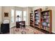 Cozy office space featuring a large bay window, built-in bookshelves, and a comfortable workspace at 1631 Caspian Dr, Carmel, IN 46032