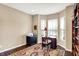 Cozy office space featuring a large bay window, built-in bookshelves, and a comfortable workspace at 1631 Caspian Dr, Carmel, IN 46032
