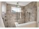 Walk-in shower with a frameless glass enclosure and tiled walls with decorative accent, handheld, and rainfall showerheads at 1631 Caspian Dr, Carmel, IN 46032