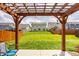 Backyard view of a pergola with chairs and tables and a large grass area at 17183 Petersfield Ln, Westfield, IN 46074