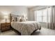 Comfortable bedroom with soft lighting, a decorative comforter, and a matching bedside table at 17183 Petersfield Ln, Westfield, IN 46074
