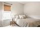 Bright bedroom with a neutral color palette, a cozy bed, and natural light from the window at 17183 Petersfield Ln, Westfield, IN 46074