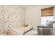 Bedroom room with animal print wallpaper accent wall and a cozy chair near the window at 17183 Petersfield Ln, Westfield, IN 46074